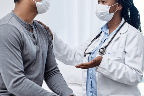 Medical worker talking to patient about asbestos exposure in Ontario Canada