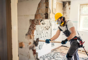 Man Demolishing Wall in Canada