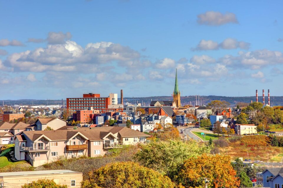 A city skyline featuring a prominent church in New Brunswick, Canada
